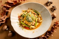 Bol de pâtes « paille et foin » garni de morceaux de poulet fermier, de champignons de saison et de légumes frais, le tout